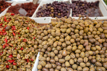 Salting olives sold on outdoor market, Sicily, Italy