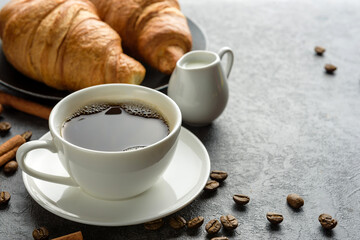 Cup of coffee and croissants close-up. Traditional breakfast concept.