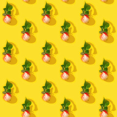 Seamless regular creative pattern from small red apples and green leaves