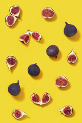 Colorful fresh figs fruit pattern on bright yellow background, whole and sliced fig.