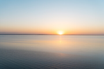 Horizontal line of calm sea at sunset