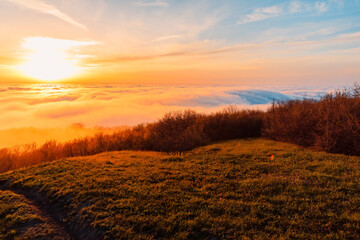 Creeping clouds with sunset on mountains.