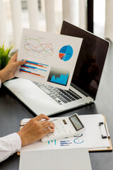 Financial Businesswomen analyze the graph of the company's performance to create profits and growth, Market research report and income statistics, Financial and Accounting concept.