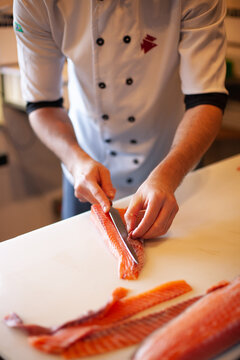 sushiman preparing salmon