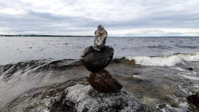 Three rocks balanced on top of each other. Shot at pyhäjärvi in Tampere, Finland.