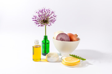 Onions, oil, cream, lemon, Aloe vera and Allium giganteum flower on white background.