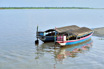 Fototapeta na wymiar Ethnic River Island Boats Are Parked On The Bank Of The River Brahmaputra