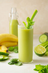 Detox green drink glass with spinach, banana, cucumber and celery. Healthy food.