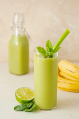 Detox drink. Green smoothie glass with fresh fruits and spinach. Healthy eating.