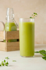 Green smoothie detox drink with apples, spinach, cucumber, lime, bananas.