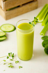 Green smoothie detox drink with apples, spinach, cucumber, lime, bananas.