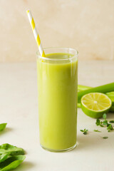 Fresh homemade green smoothie detox drink with spinach, cucumber, lime, bananas.