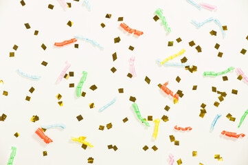 golden confetti and colored spirals on a light background