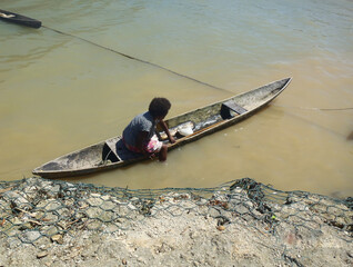 Person canoeing in the wodden handmaid canoe 