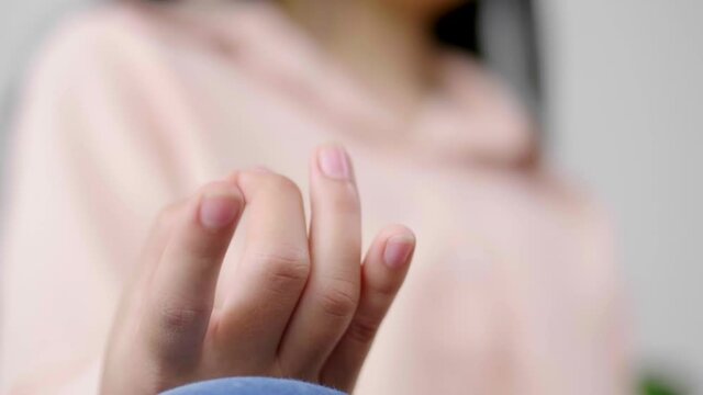 Close up hand of Asian woman doing meditation and sitting in lotus pose on couch, stress relief self-control concept, woman work out by doing meditation in living room at home during covid19