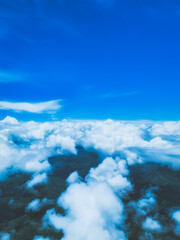Cinematic tone aerial view ; Enchanted puffy cloud covering the mountain with blue sky , calm and meditation concept