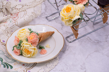 Beautiful piped buttercream flowers in cone cupcakes on stylish table