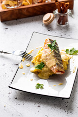 Cooked salmon with mashed potatoes and sauce