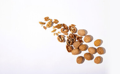 Walnut and a cracked walnut on the white background