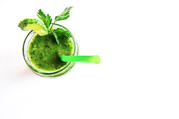 Green cocktail of spinach, lemon, cucumber and parsley on a light background. The concept of healthy nutrition, detox, green, diet, vegan, keto, fit. Top view. Copy space.