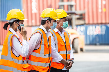 Group of construction worker wearing protective mask meeting and discussing for work at warehouse distribution. logistics business, export or import factory.