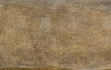 Brown aged texture of stone with cracks. Wet rock surface