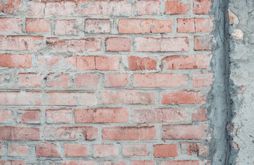 Old brick wall for texture or background, rough aged brickwork with remnants of peeling plaster,...