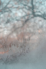 Beautiful winter background, frost on the window, natural texture on glass with a frozen pattern....