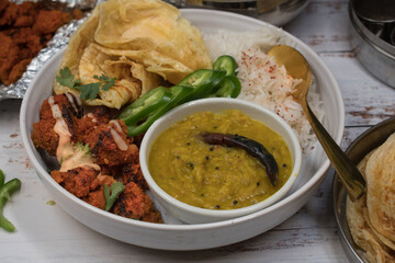Indian vegan dishes served in bowls, tandoori seitan, paratha, rice
