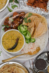 Indian vegan dishes served in bowls, tandoori seitan, paratha, rice