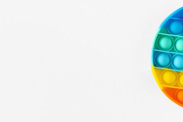 Color pop it antistress toy for children. rainbow circle shaped isolated on white background . Pop it toy.Copy space.Place for text