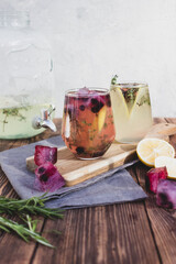 Summer drink with lemon and berries on a wooden background