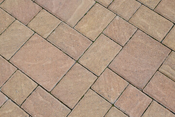 Stone block pavement. Brown paving slabs, close up. Pattern of paving blocks, top view
