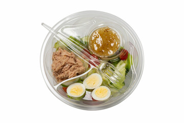 Fresh tuna salad with lettuce, cucombers, cherries and eggs in plastic container.