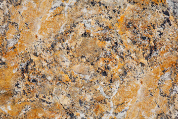 abstract texture of the stone in yellow color with black and white veins