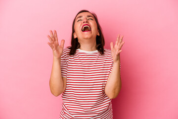 Middle age caucasian woman isolated on pink background laughs out loudly keeping hand on chest.