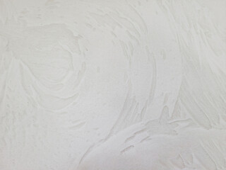 Close up of beige painted wall with stucco swirl pattern