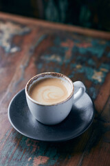 Cup of coffee on wooden background. Close up.	