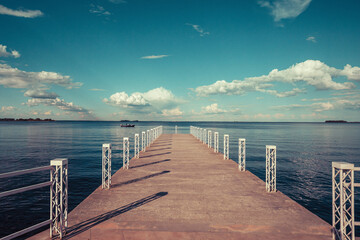 A boat dock on the river under a cloudy sky