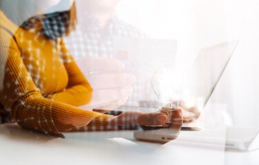 Digital marketing media in virtual screen.businesswoman hand working with mobile phone and modern compute with VR icon diagram at office in morning light
