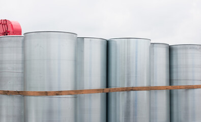 metal silver barrels in a bundle. Transportation of containers