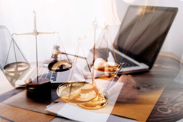 Justice and law concept.Male judge in a courtroom with the gavel, working with, computer and docking keyboard, eyeglasses, on table in morning light