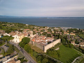 Italy, May 2021- aerial view of the town of Moniga del Garda with the lake in the background together with Sirmione in the province of Brescia in the Lombardy region