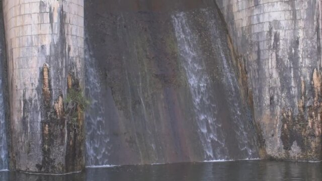 Closeup video of white water stream flowing through a dam
