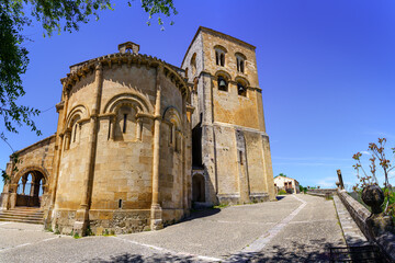 Fototapeta na wymiar Old Romanesque church with its bell tower and sunny blue sky.