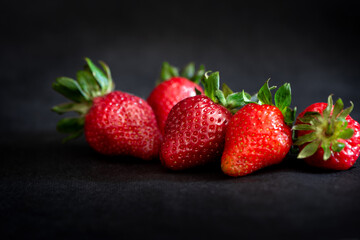 Fototapeta na wymiar Ripe red strawberries on black background