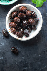 olives dried sun-dried tasty olive dry fruit appetizer salad addition on the table healthy food meal snack copy space food background rustic 