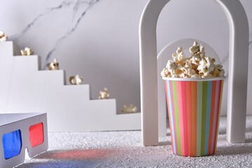 Striped paper cup with popcorn in a decorative arch