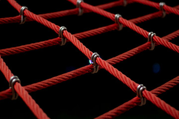 Ropes in the playground. Climbing net, shot close-up. Ropes fastened with links.