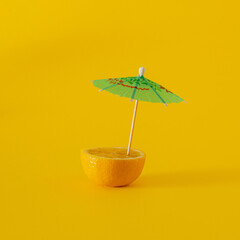 fresh yellow lemon with green parason on yellow illuminating background. summer abstract art. minimaism